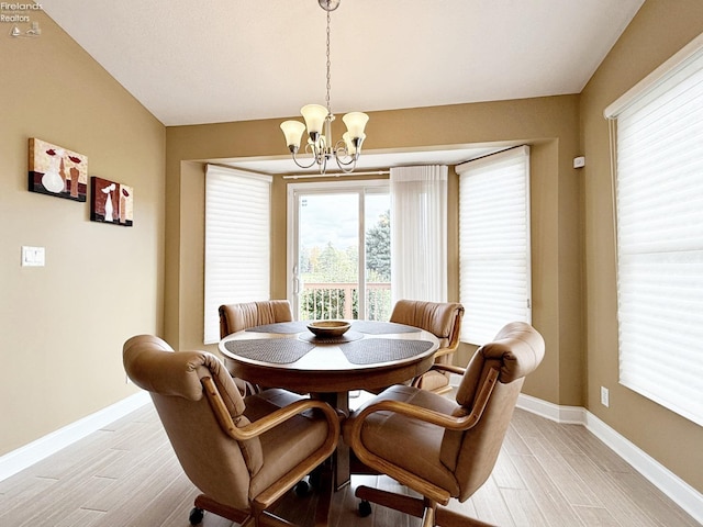 dining space with a chandelier and light hardwood / wood-style floors