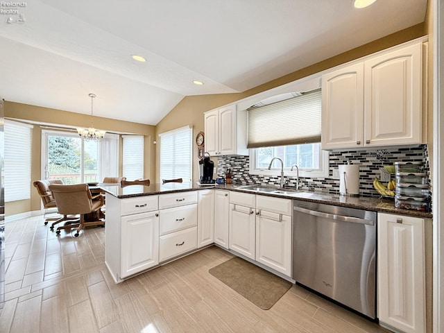 kitchen with decorative backsplash, a wealth of natural light, kitchen peninsula, and stainless steel dishwasher