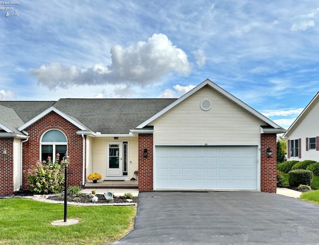 view of front of home with a front yard and a garage