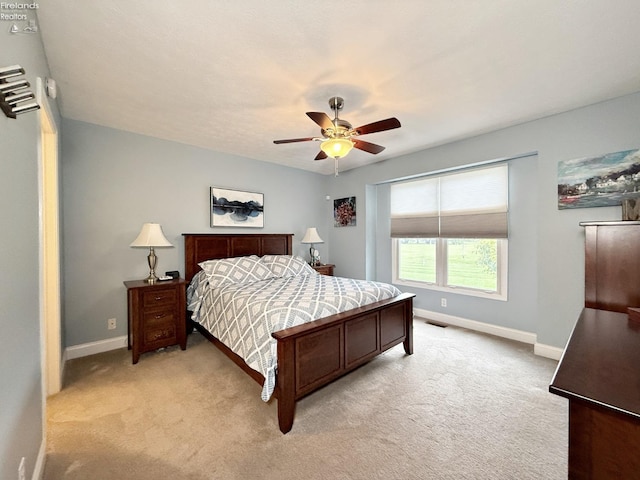 bedroom with light colored carpet and ceiling fan