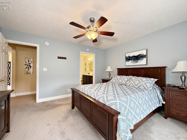 carpeted bedroom with ceiling fan, connected bathroom, and a textured ceiling