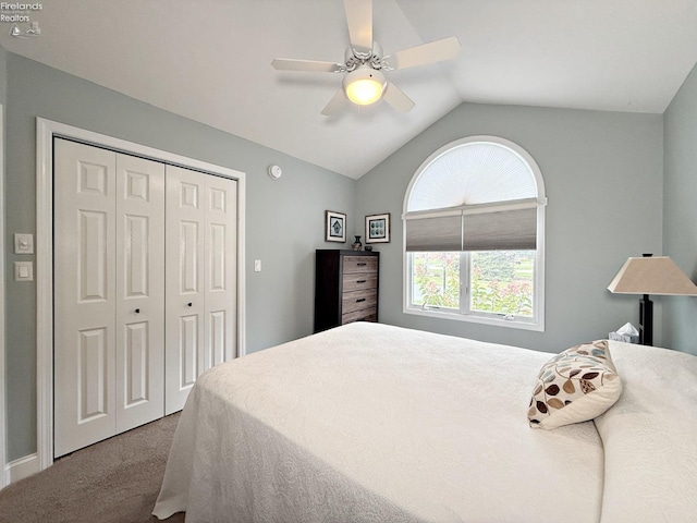 carpeted bedroom featuring lofted ceiling, ceiling fan, and a closet