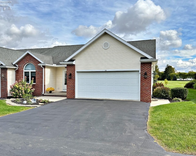 view of front of house with a front yard and a garage