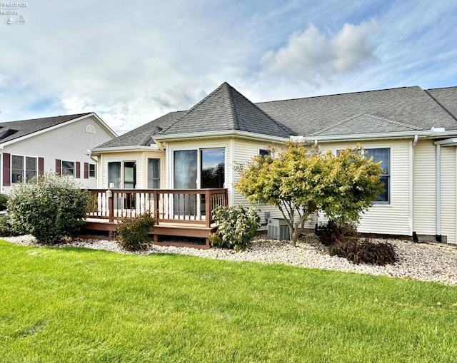 back of house with a wooden deck and a yard