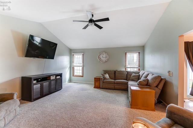 living room with ceiling fan, vaulted ceiling, and light colored carpet