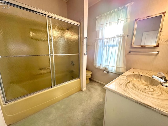 full bathroom featuring vanity, toilet, and enclosed tub / shower combo