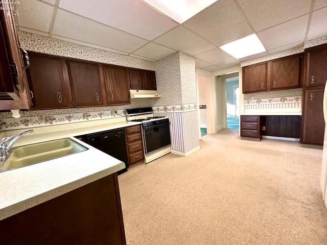 kitchen with black dishwasher, gas range gas stove, a drop ceiling, dark brown cabinetry, and sink