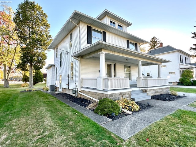 view of front facade with central air condition unit, covered porch, and a front lawn