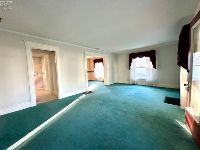 empty room with ornamental molding and carpet floors