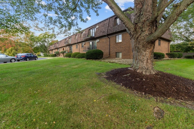 view of side of home with a yard