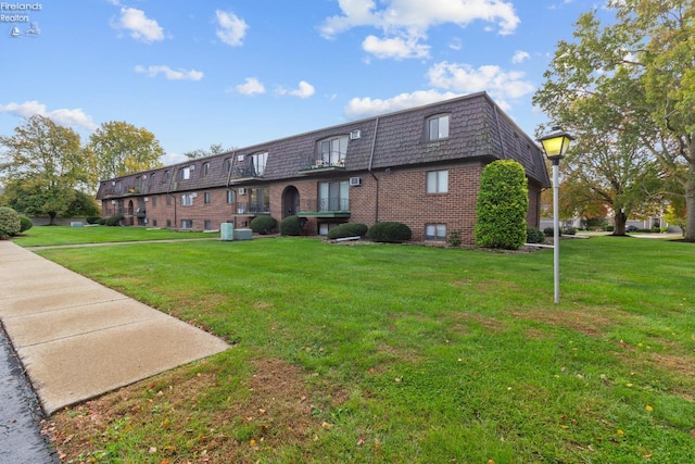 rear view of property with a lawn