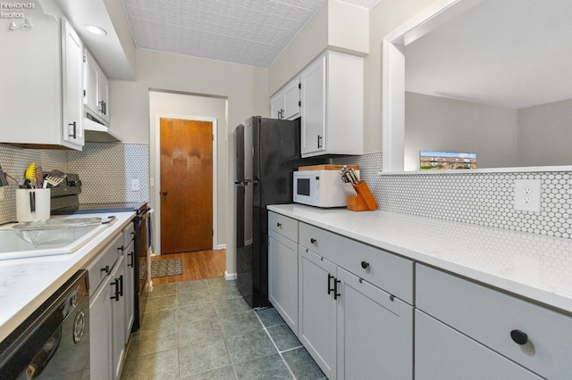 kitchen featuring white appliances, tasteful backsplash, tile patterned floors, and gray cabinetry