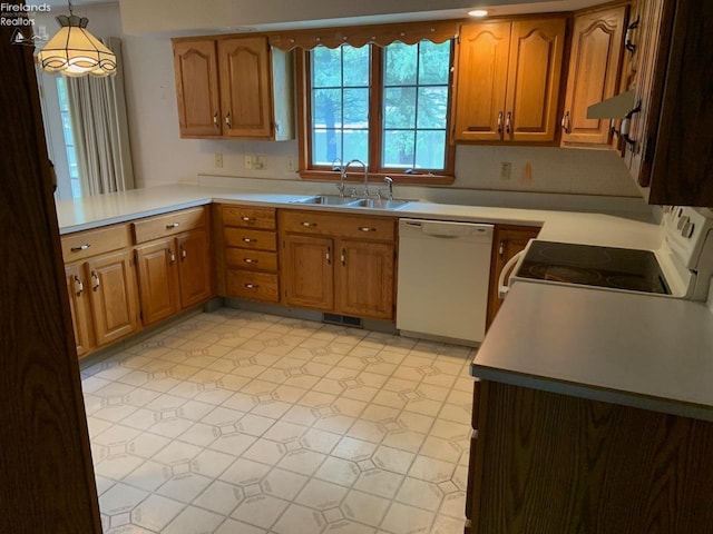 kitchen with kitchen peninsula, sink, hanging light fixtures, and white appliances