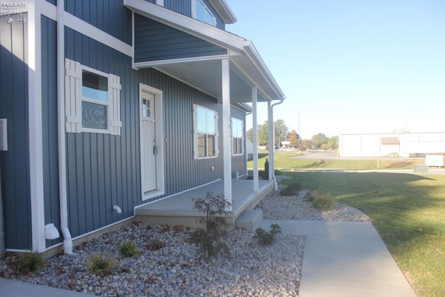 entrance to property with a lawn