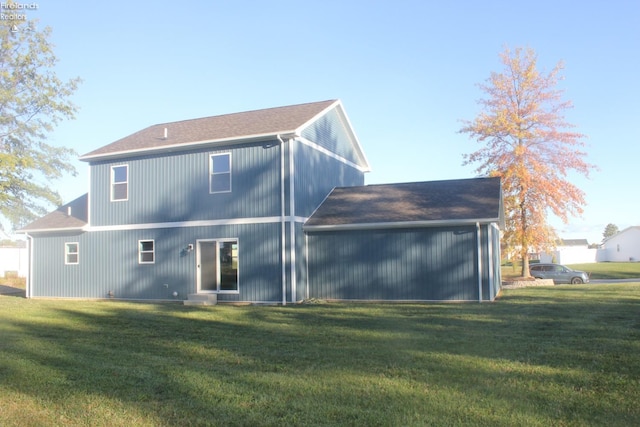 rear view of house featuring a yard