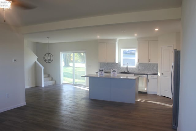 kitchen with white cabinetry, sink, dark wood-type flooring, and a kitchen island