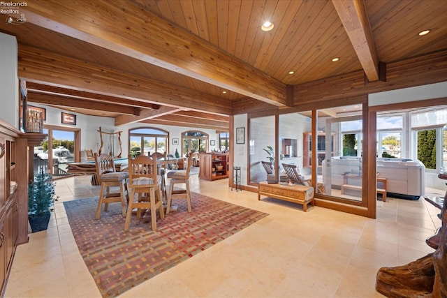 dining room with wood ceiling, a healthy amount of sunlight, and light tile patterned floors