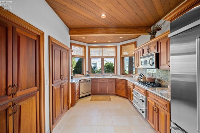 kitchen featuring beamed ceiling, decorative backsplash, stainless steel appliances, and sink