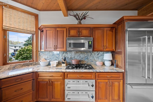 kitchen featuring wood ceiling, decorative backsplash, beam ceiling, light stone countertops, and stainless steel appliances