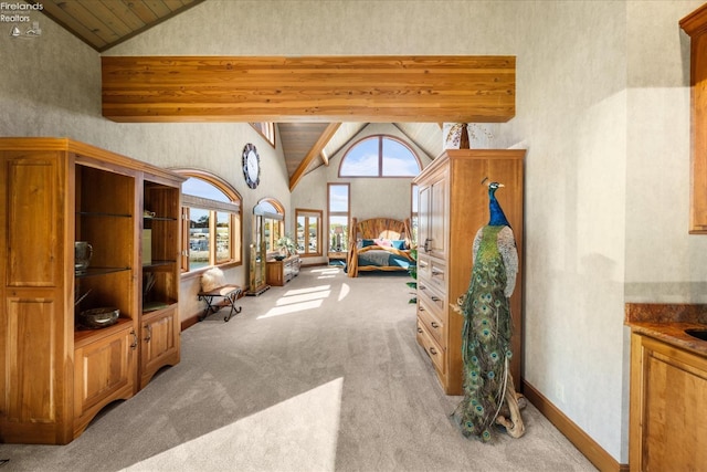 interior space featuring beam ceiling and high vaulted ceiling