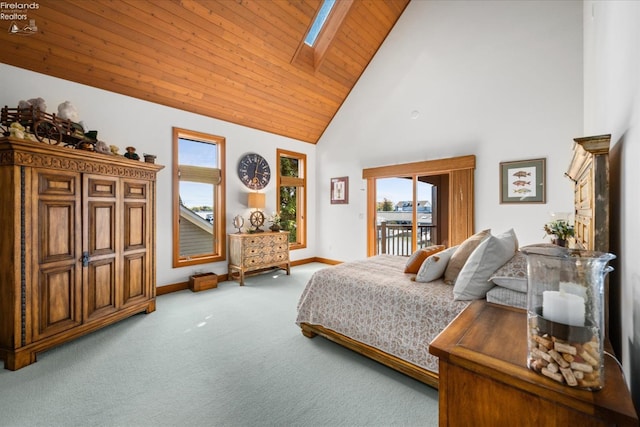 bedroom featuring wood ceiling, access to exterior, carpet floors, high vaulted ceiling, and a skylight