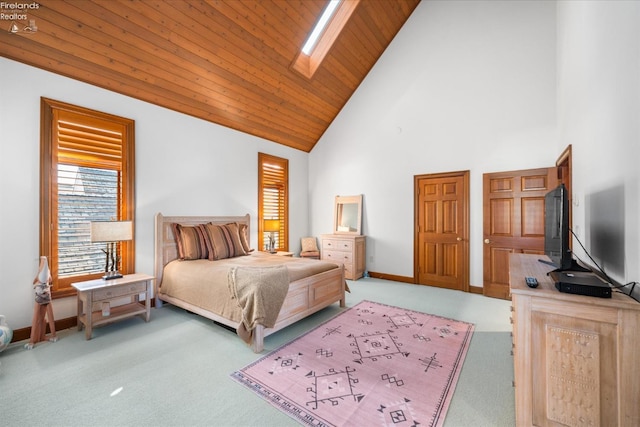 carpeted bedroom featuring wood ceiling, high vaulted ceiling, and a skylight