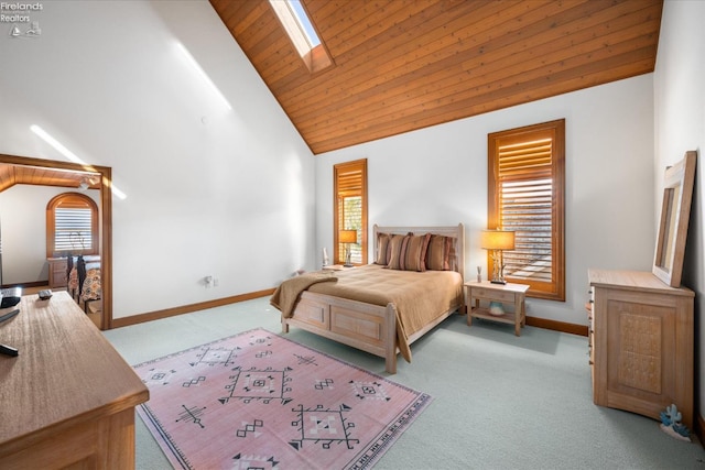 bedroom with light carpet, high vaulted ceiling, wooden ceiling, and a skylight