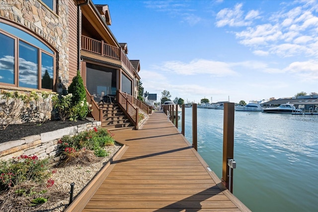 view of dock with a water view and a balcony