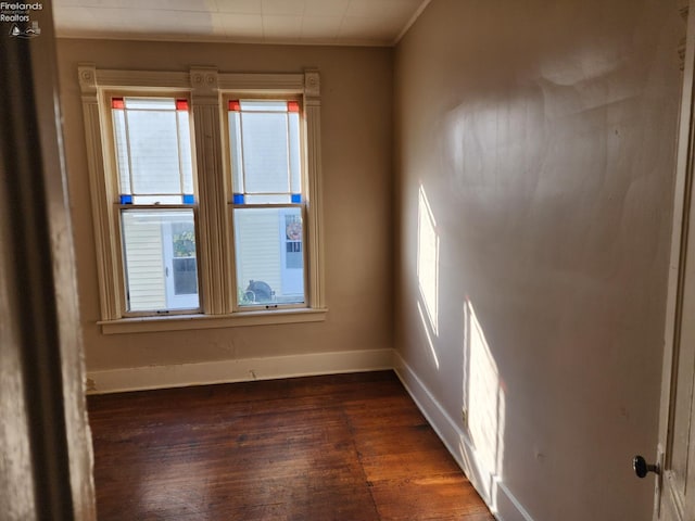 unfurnished room featuring crown molding and dark hardwood / wood-style floors