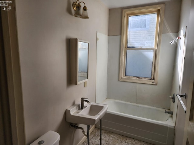 full bathroom featuring sink, toilet, tile patterned floors, and shower / tub combination