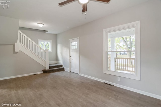 foyer entrance with ceiling fan and hardwood / wood-style flooring