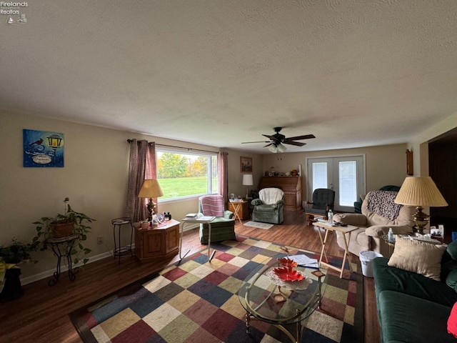 living room with hardwood / wood-style floors, a textured ceiling, and ceiling fan