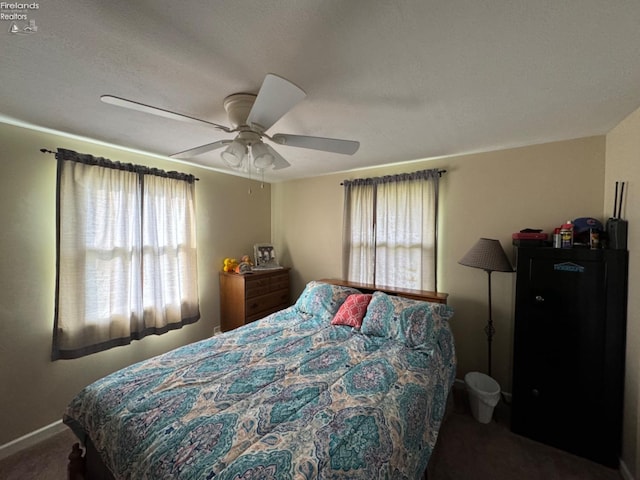 carpeted bedroom with multiple windows, a textured ceiling, and ceiling fan