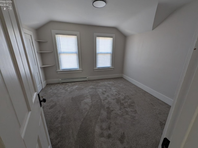 additional living space featuring a baseboard radiator, carpet, and vaulted ceiling