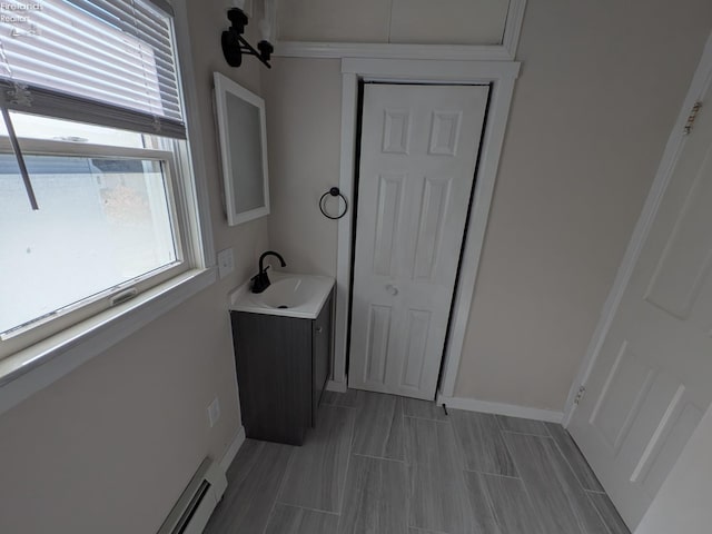 bathroom featuring vanity and a baseboard heating unit