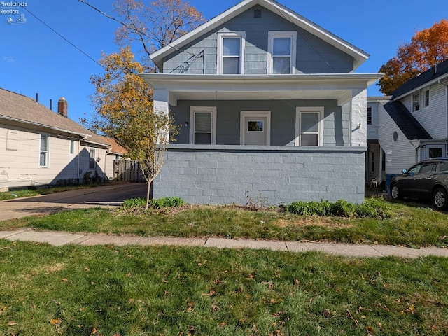 bungalow-style home with a front lawn