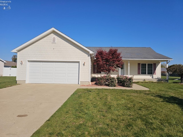 ranch-style house featuring covered porch, a garage, and a front lawn