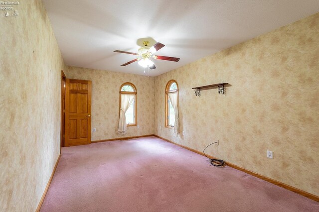 empty room featuring light colored carpet and ceiling fan