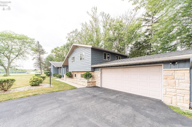 view of side of home with a yard and a garage