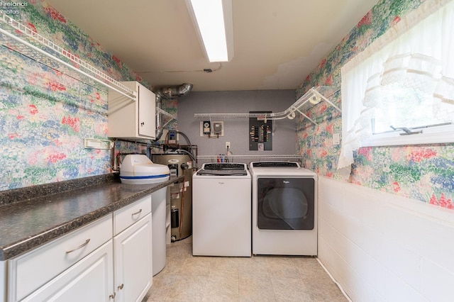 washroom with cabinets, electric water heater, electric panel, washing machine and clothes dryer, and light tile patterned flooring