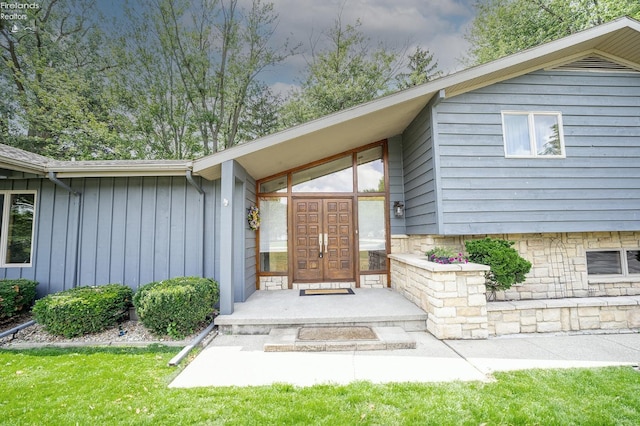 entrance to property featuring a yard