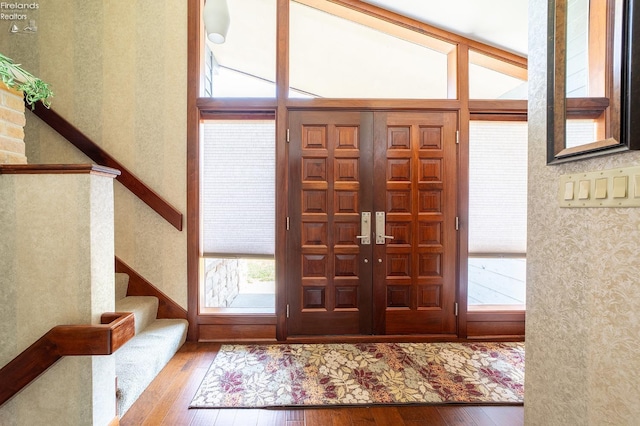 foyer with lofted ceiling and hardwood / wood-style flooring