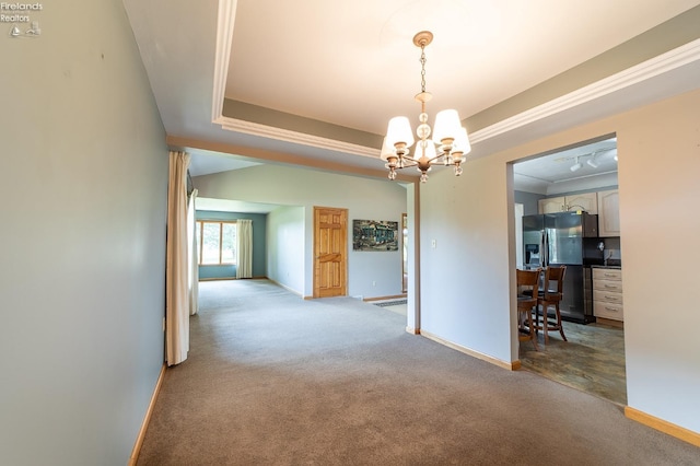 unfurnished dining area with a notable chandelier, light colored carpet, crown molding, and a raised ceiling