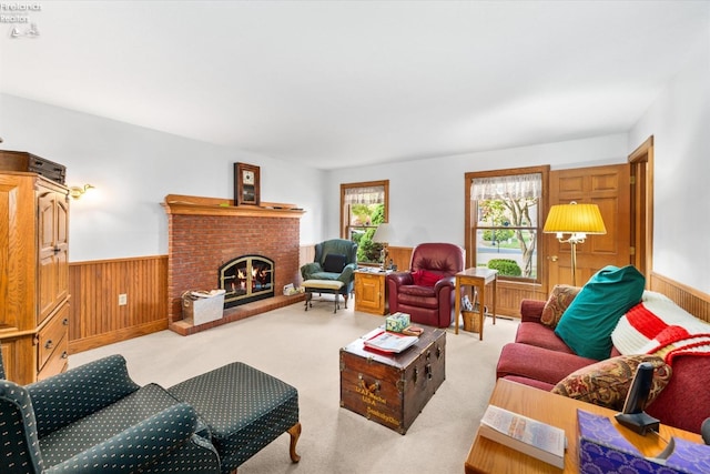 living room featuring light carpet, wood walls, and a fireplace