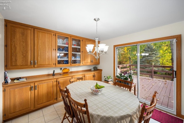 tiled dining area with a chandelier