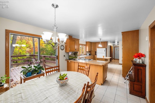 tiled dining area featuring an inviting chandelier