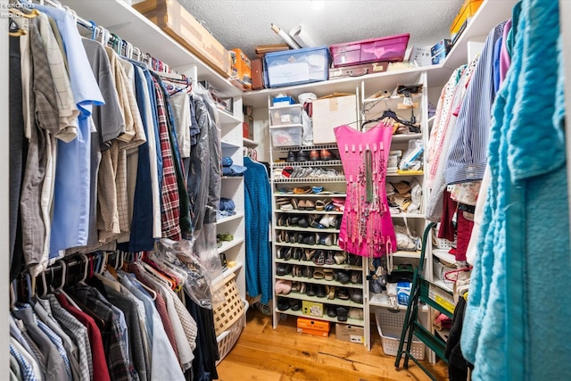 walk in closet with hardwood / wood-style floors