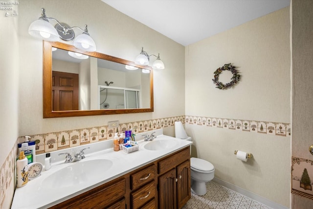 bathroom featuring vanity, toilet, and an enclosed shower