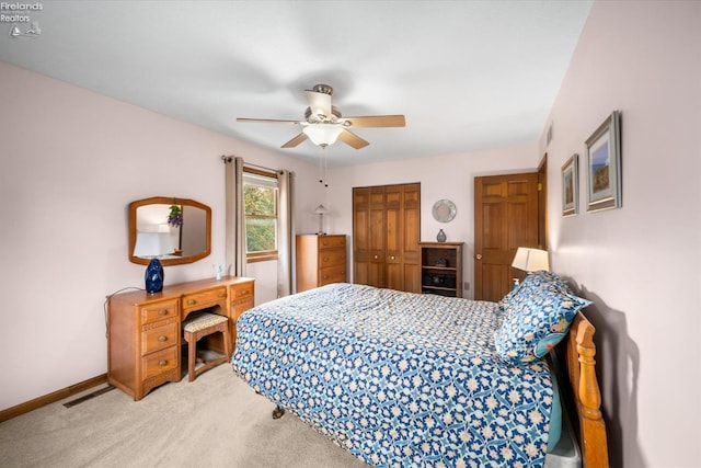 carpeted bedroom featuring a closet and ceiling fan