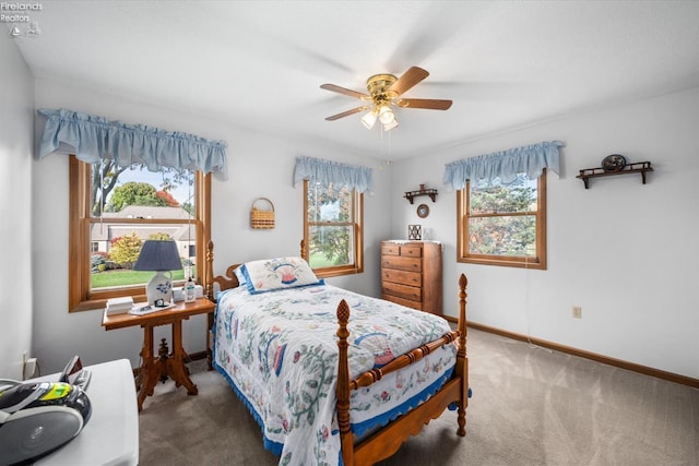 bedroom with ceiling fan, carpet flooring, and multiple windows